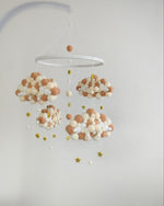 Giostrина musicale culla nuvole in pon pon di feltro beige panna e bianco con stelline glitter oro