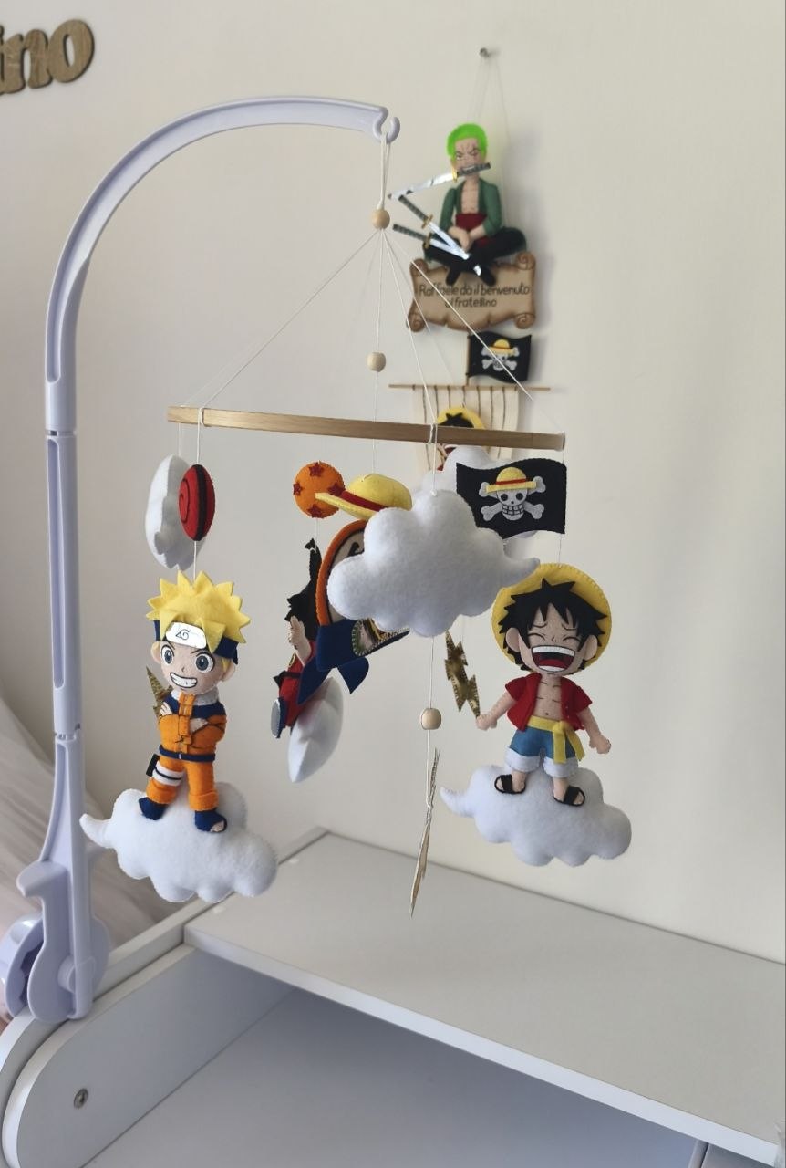 Giostrina musicale anime vista di lato: Naruto, Luffy, bandiera pirata e fulmini dorati in feltro