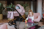 Lifestyle – passeggino Kunert Ivento eco-pelle rosa metallic con borsa abbinata e bambina che gioca