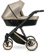 Navicella Kunert Ivento ecopelle beige dorato con telaio nero e barra oro, ruote cerchi dorati, vista laterale
