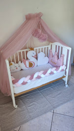 Lettino bimba rosa con paracolpi a treccia, velo baldacchino e cuscini a forma di cigno e corona 